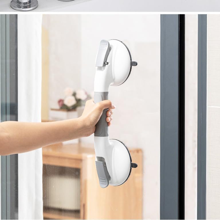 Suction grab bar mounted beside a glass shower enclosure