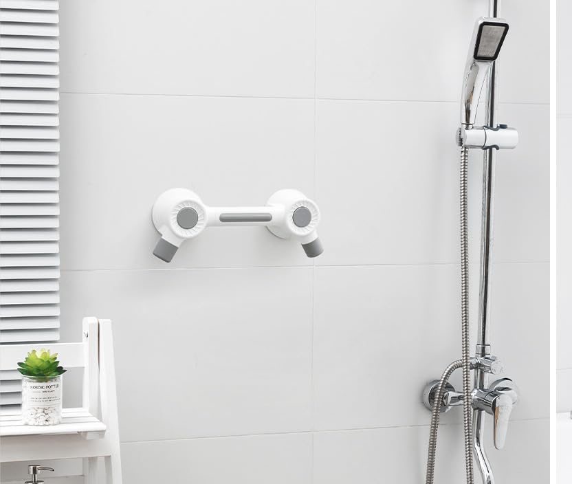 Grab bar mounted on a smooth tiled bathroom wall next to a shower